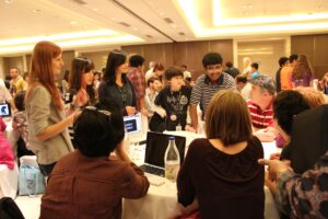 Image: Students and Teachers Collaborating at a Flat Classroom Event. Title: Global education: Supporting collaborative learning and teaching